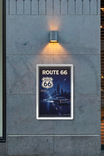 Route 66 poster on a wall with a light fixture above