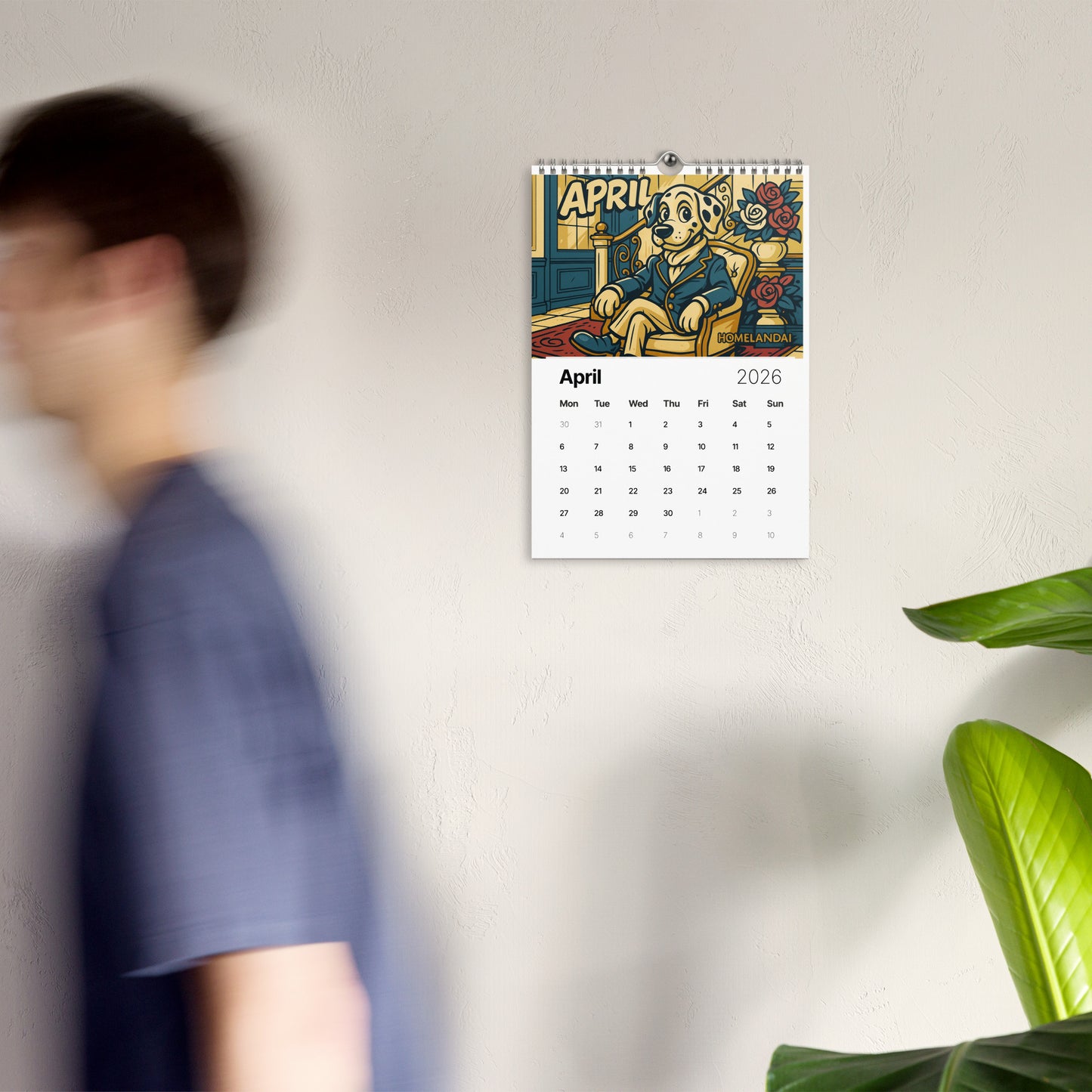 Calendar on a wall with a person and plant in the foreground